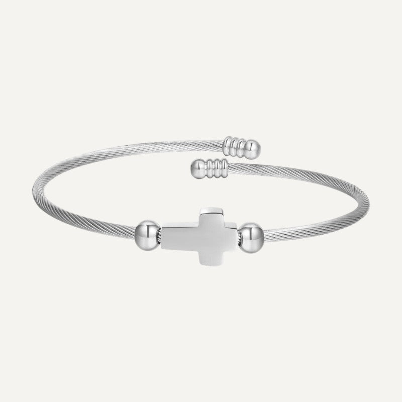 Gedrehte Armspange mit Kreuz